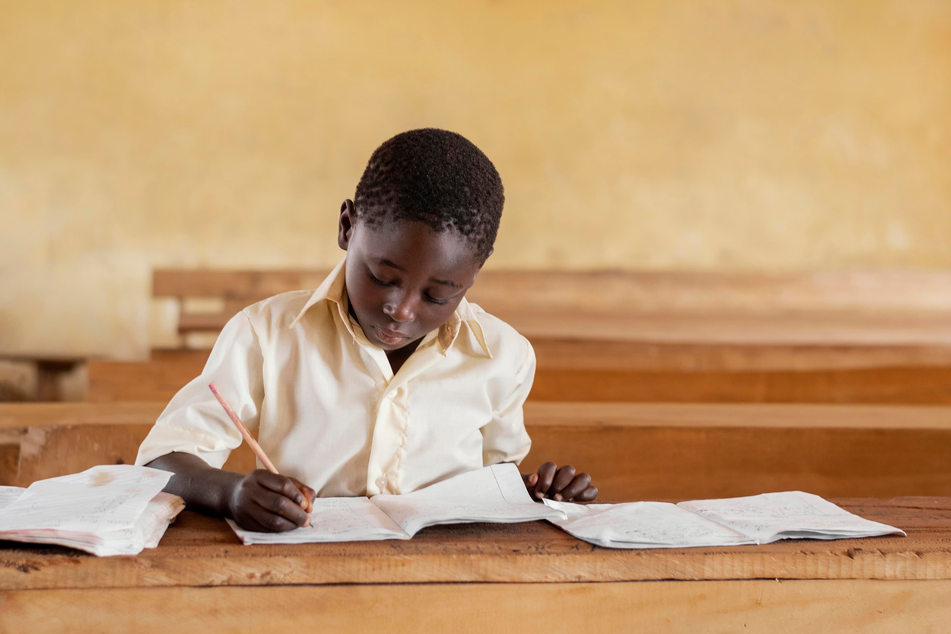 Junior high student reading their BECE results in Ghana